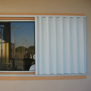 Accordion shutters protecting patio doors